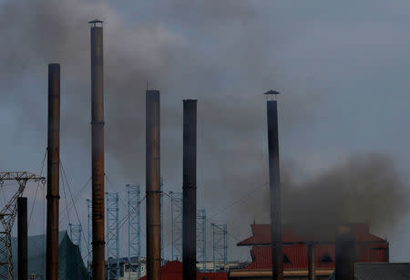 Smoke rises from the chimney of a paper factory outside Hanoi, Vietnam May 21, 2018. Picture taken May 21, 2018. REUTERS/Kham