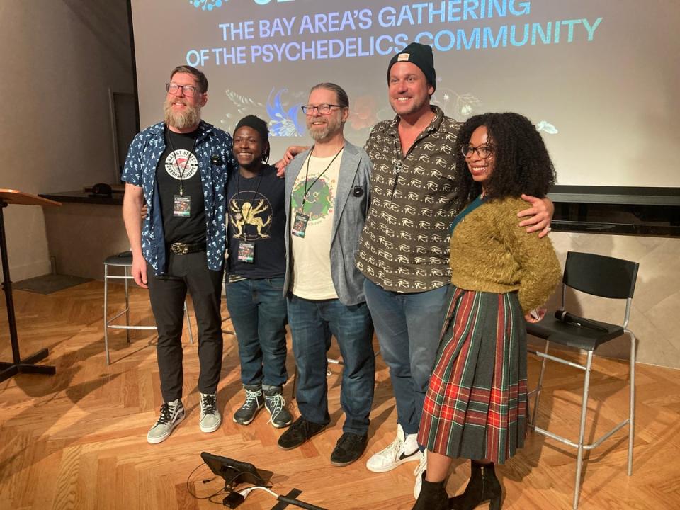 Niko Summers, second from left, Larry Norris, middle, and Dennis Walker, second from right, pose after a panel on psychedelic entrepreneurship (Io Dodds / The Independent)