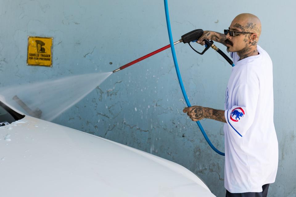 El Paso Chicano rap artist Fabian Primera 'Payaso915' washes his car at the Self Service California Car Wash in El Paso, Texas, on Thursday, July 20, 2023.