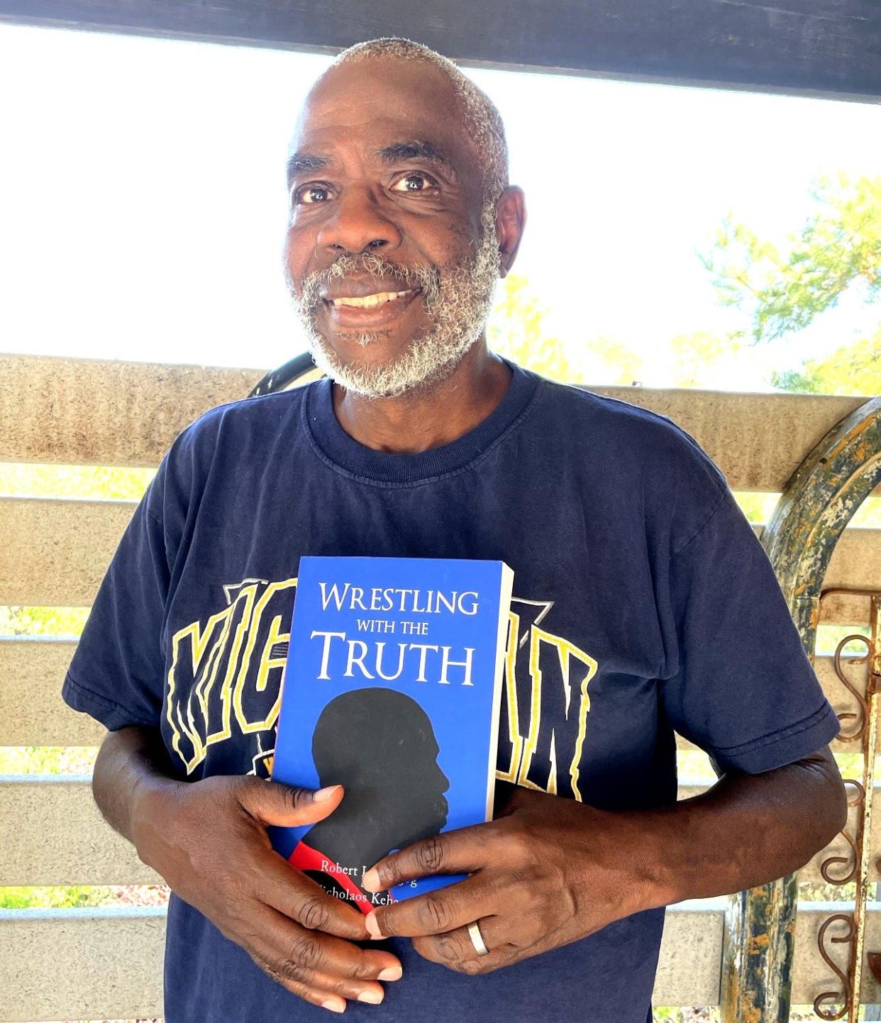 Robert L. Shegog displays his book "Wrestling with the Truth."