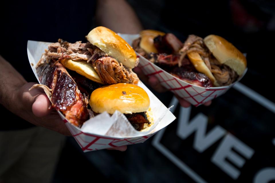 Mike Shannon holds two orders of ribs, brisket, and pulled pork during the 36th annual Main Street Festival in Franklin on Saturday, April 27, 2019. "It's heaven," he said.