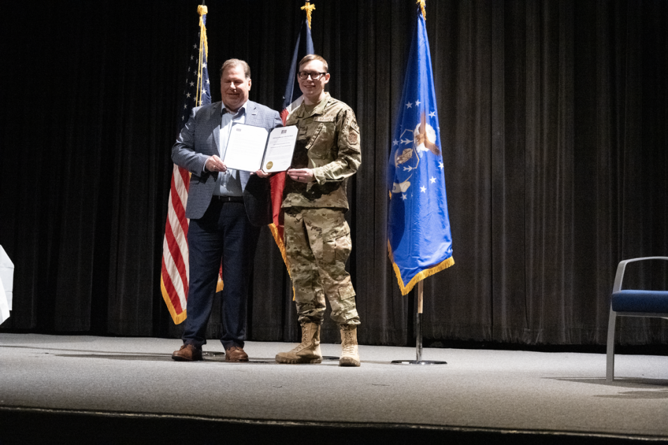 Gary Cole, regional USO president, presents Staff Sgt. Cody Foster the National Guardsman of the Year award at a Nov. 4, 2023, ceremony held at the Naval Air Station Joint Reserve Base Fort Worth, where Foster is stationed.