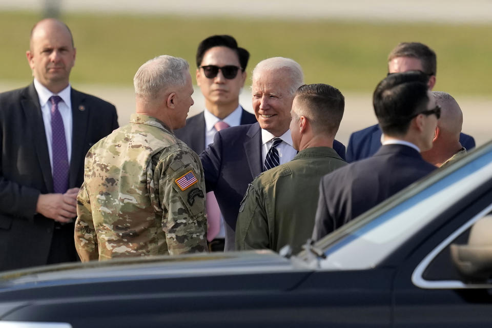 U.S. President Joe Biden, center, is greeted on his arrival at Osan Air Base in Pyeongtaek, South Korea, Friday, May 20, 2022. (AP Photo/Lee Jin-man, Pool)