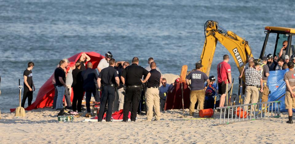 Emergency personnel work to recover a man who was killed in a sand hole collapse at the end of East Bonita Way in the Ocean Beach III section of Toms River Tuesday evening, May 17, 2022.