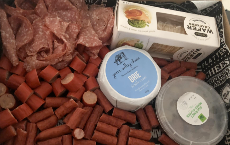 A $12 Woolworths grazing platter featuring brie, crackers, olives, cabanossi and salami