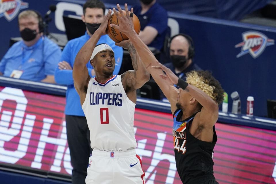 Clippers guard Jay Scrubb takes a jump shot against Thunder forward Charlie Brown Jr.