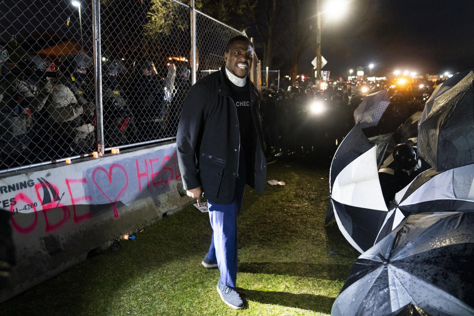 Michael Odiari argues with demonstrators to stop attempting to agitate authorities by advancing on a perimeter security fence during a protest decrying the shooting death of Daunte Wright outside the Brooklyn Center Police Department, Wednesday, April 14, 2021, in Brooklyn Center, Minn. (AP Photo/John Minchillo)