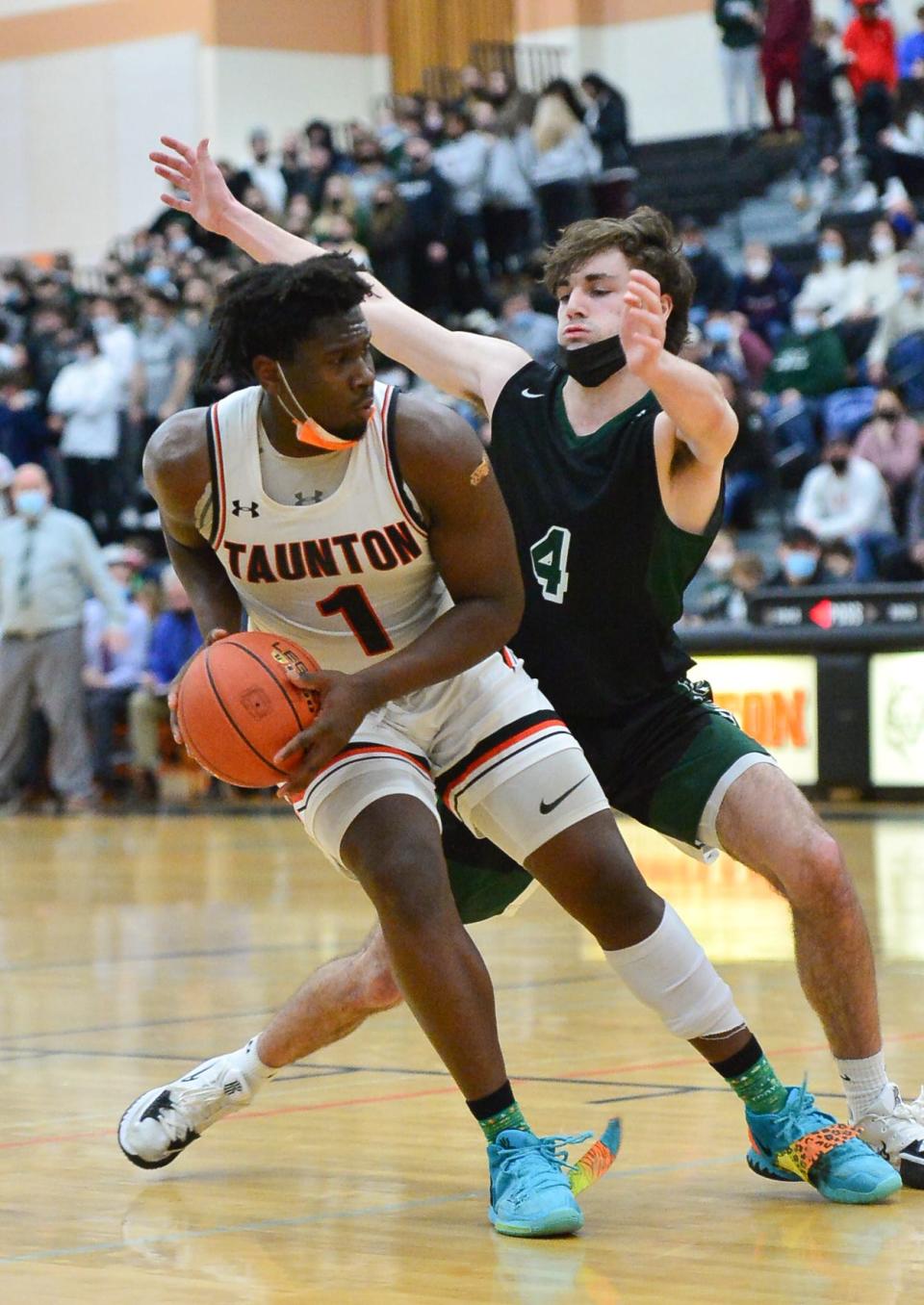 Mansfield's Trevor Foley guards Taunton's Faisal Mass during Tuesday night's game.