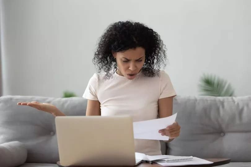 Woman shocked reading a letter