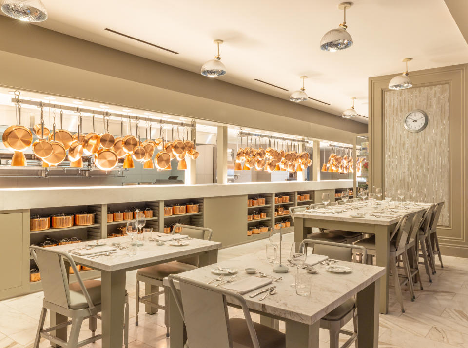 The bright open kitchen at the Bedford is adorned with copper pots and pans and overlooks 