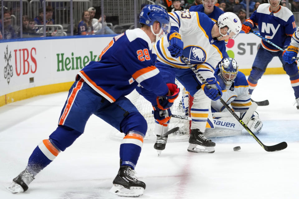 Buffalo Sabres goaltender Eric Comrie (31) and left wing Jeff Skinner (53) tends net against New York Islanders center Brock Nelson (29) during the second period of an NHL hockey game, Saturday, March 25, 2023, in Elmont, N.Y. (AP Photo/Mary Altaffer)