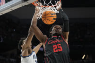 Houston center Josh Carlton dunks in front of Villanova forward Jermaine Samuels during the first half of a college basketball game in the Elite Eight round of the NCAA tournament on Saturday, March 26, 2022, in San Antonio. (AP Photo/David J. Phillip)