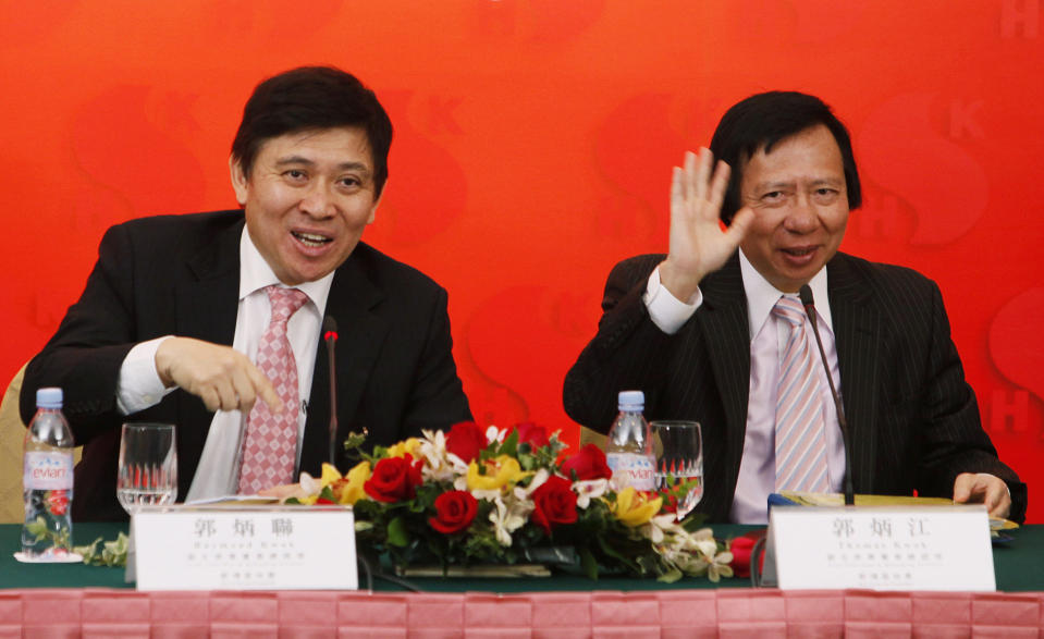 FILE - In this March 11, 2010 file photo Sun Hung Kai Properties Co-Vice Chairmen, Thomas Kwok Ping Kwong, right, and Raymond Kwok Ping Luen,speak during a company interim results announcement for 2009-1010 in Hong Kong. Hong Kong's anti-corruption watchdog has arrested two senior executives at a listed company and a former senior government official for suspected corruption. The Independent Commission Against Corruption said Thursday the three are alleged to have committed bribery and misconduct in public office offenses. It did not name them. (AP Photo/Kin Cheung, File)