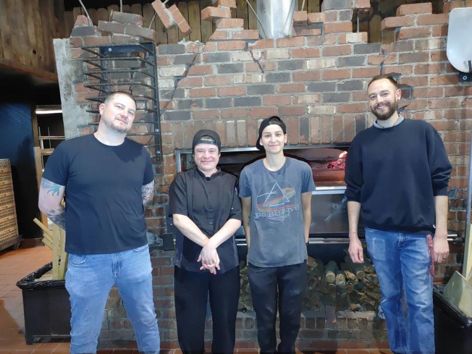 Chad Diaz, owner and operator of Hellfired Pizza, stands in front of the pizza oven with his team, from left, Laura Moxley, Sonia Whitney and general manager Jason Door. The former Rock Wood Fried Pizza in Kennewick reopened this week with the same owners and staff but a new brand.