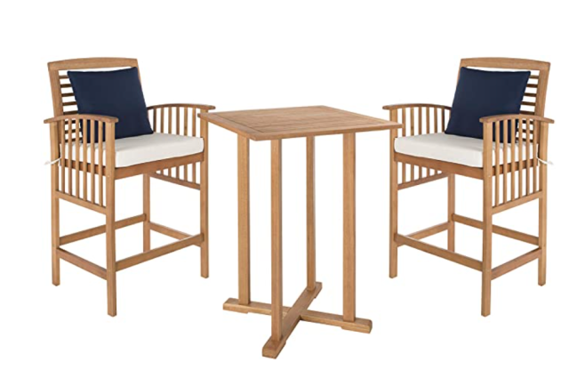 wood high top table and bar stools with navy throw pillows