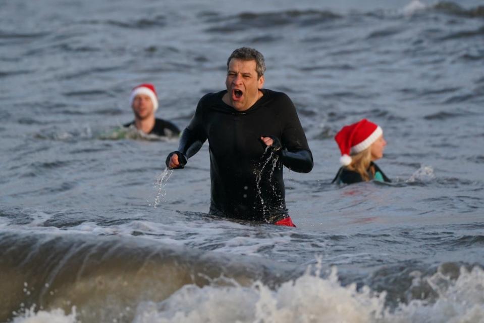 Swimmers tried to forget the chill as they took a Christmas Day dip (Andrew Milligan/PA) (PA Wire)