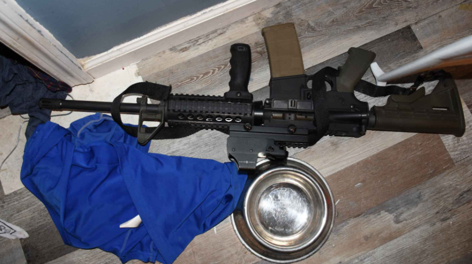 This crime scene photo shows the AR-15 rifle that was found under a shirt (which was since pulled beside it) on the master bedroom floor in Daniel Palato's home after he was shot and killed by Clay County deputies following a chase on April 27, 2022. Deputies and Orange Park police officers believed Palato was armed with the weapon.