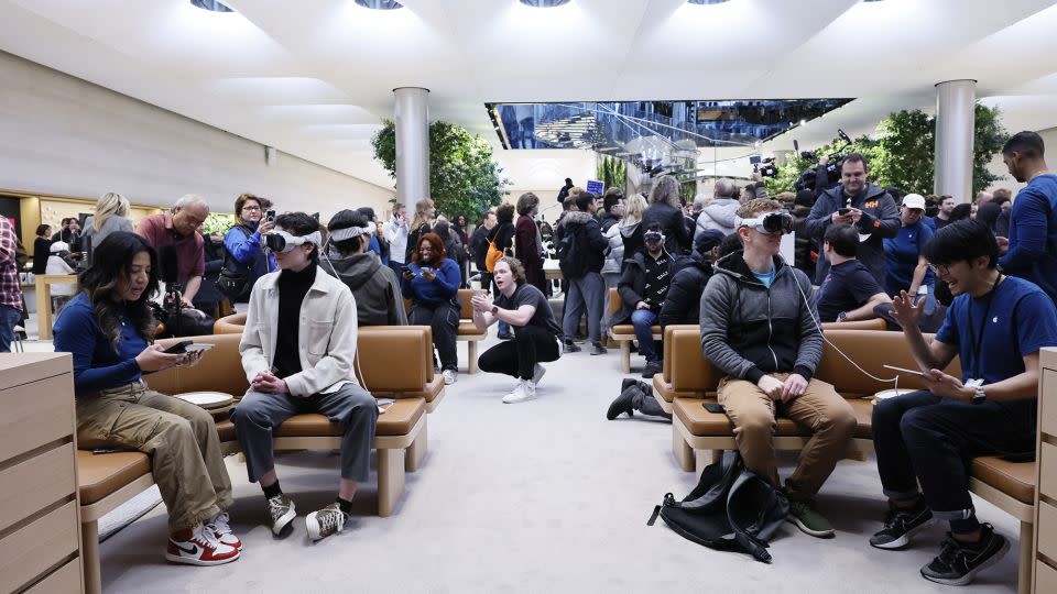 People experience a demo of the Apple Vision Pro headset at the Fifth Avenue Apple store on February 02, 2024 in New York City. Apple CEO Tim Cook and Senior Vice President of Retail and People Deirdre O'Brien were at the opening of the Apple store on Fifth Avenue as the company begins its sale of the Vision Pro headset, the company's first new product in seven years. - Michael M. Santiago/Getty Images