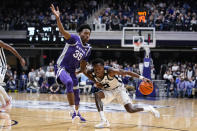 Butler guard Eric Hunter Jr. (2) drives under Kansas State forward Nae'Qwan Tomlin (35) in the first half of an NCAA college basketball game in Indianapolis, Wednesday, Nov. 30, 2022. (AP Photo/Michael Conroy)