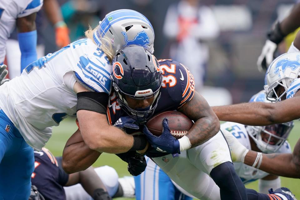 Chicago Bears running back David Montgomery (32) scores as Detroit Lions middle linebacker Alex Anzalone defends during the first half of an NFL football game Sunday, Oct. 3, 2021, in Chicago.