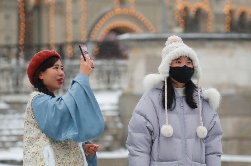 Chinese young women are pictured wearing mask in the Red Square in Moscow