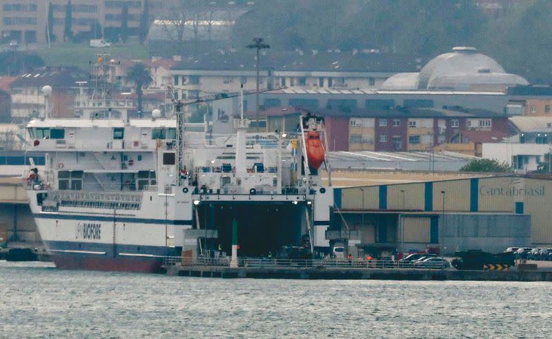 Leopard 2 6A4 tanks are driven onto a cargo ship at the port of Santander