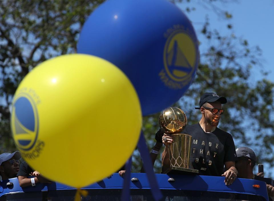 <p>Golden State Warriors Stephen Curry holds the Larry O’Brien NBA Championship Trophy during the Warriors Victory Parade on June 15, 2017 in Oakland, California. An estimated crowd of over 1 million people came out to cheer on the Golden State Warriors during their victory parade after winning the 2017 NBA Championship. (Photo by Justin Sullivan/Getty Images) </p>