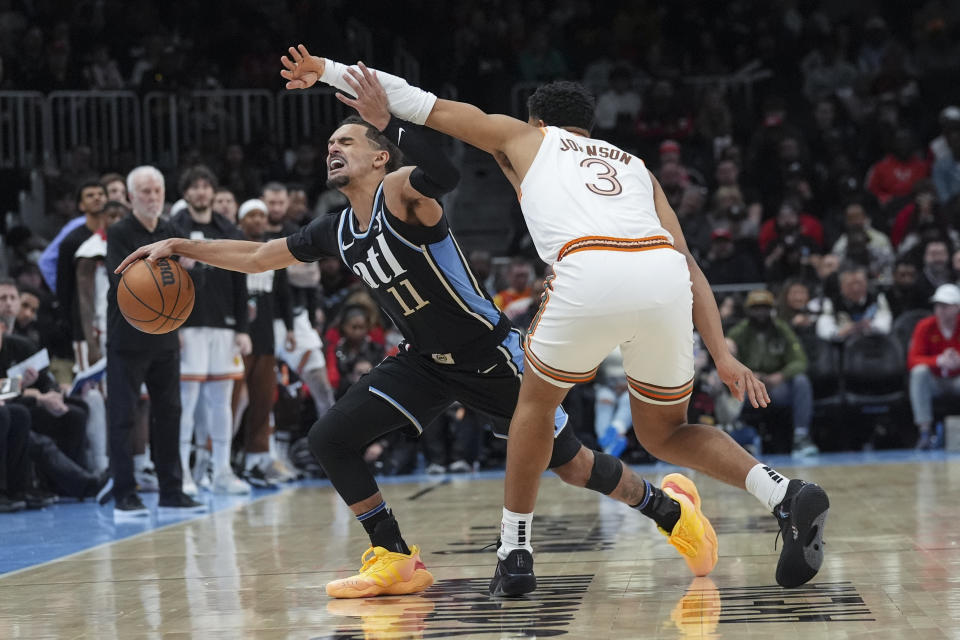 Atlanta Hawks guard Trae Young (11) drives agaainst San Antonio Spurs forward Keldon Johnson (3) during the second half of an NBA basketball game Monday, Jan. 15, 2024, in Atlanta. (AP Photo/John Bazemore)