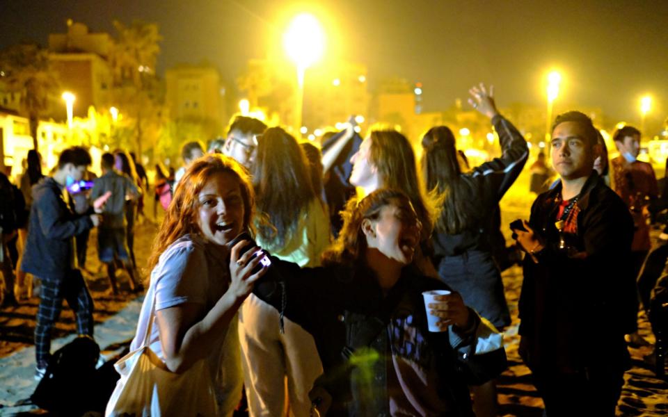 People dance at the Barcelona beach, as the state of alarm decreed by the Spanish Government is due to end on Sunday - Reuters