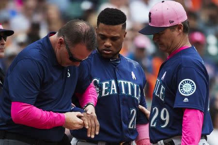 FILE PHOTO: May 13, 2018; Detroit, MI, USA; Seattle Mariners second baseman Robinson Cano (22) is checked by medical staff and manager Scott Servais (29) after being hit by a pitch in the third inning against the Detroit Tigers at Comerica Park. Mandatory Credit: Rick Osentoski-USA TODAY Sports