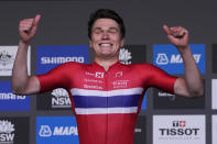 Norway's Soren Waerenskjold celebrates winning the gold medal in the men's under 23 individual time trial at the world road cycling championships in Wollongong, Australia, Monday, Sept. 19, 2022. (AP Photo/Rick Rycroft)