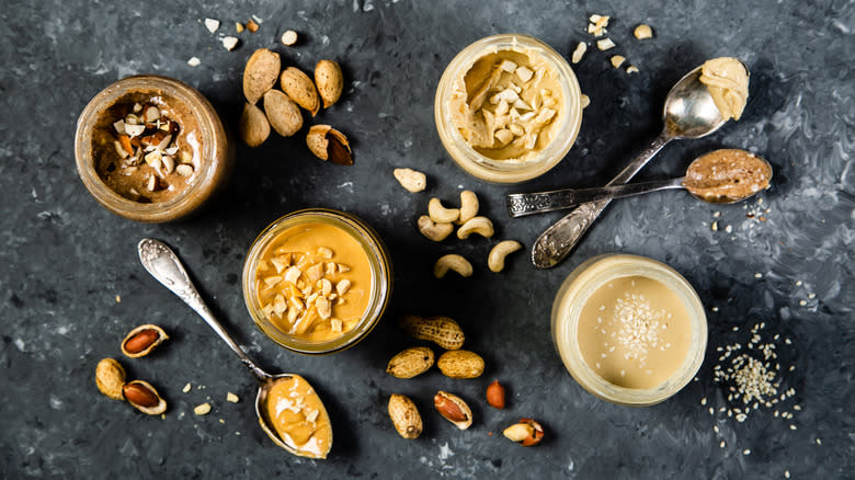 Jars and spoonfuls of nut butters