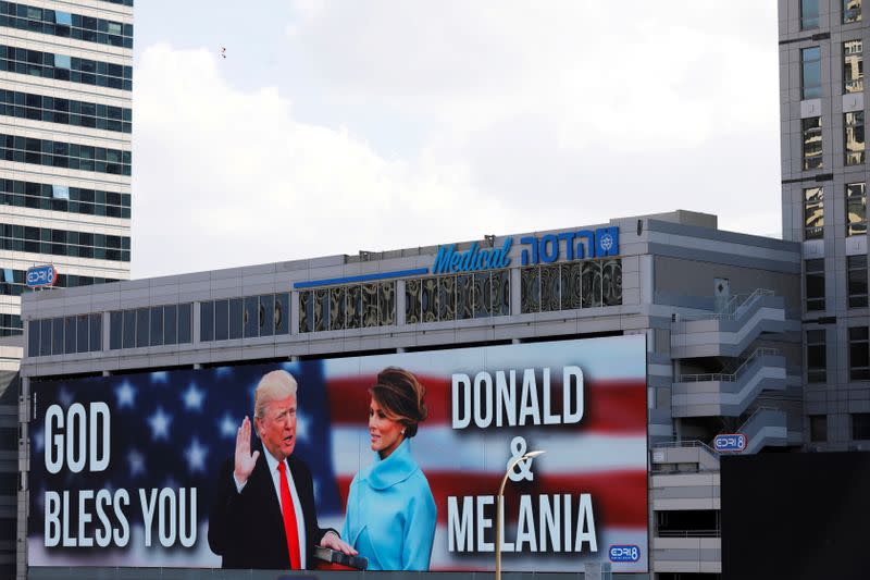 FILE PHOTO: A billboard depicting U.S. President Donald Trump and his wife Melania with the American flag and the words, "God Bless You" is seen along a highway in Tel Aviv, Israel