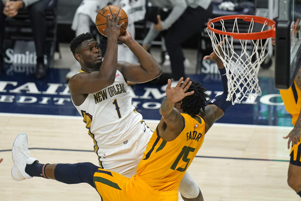 New Orleans Pelicans forward Zion Williamson (1) shoots as Utah Jazz center Derrick Favors (15) defends during the first half of an NBA basketball game Tuesday, Jan. 19, 2021, in Salt Lake City. (AP Photo/Rick Bowmer)