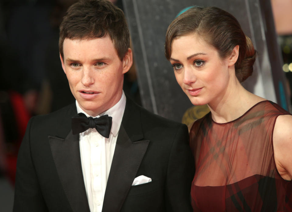 Actors Eddie Redmayne and Hannah Bagshawe pose for photographers on the red carpet at the EE British Academy Film Awards held at the Royal Opera House on Sunday Feb. 16, 2014, in London. (Photo by Joel Ryan/Invision/AP)