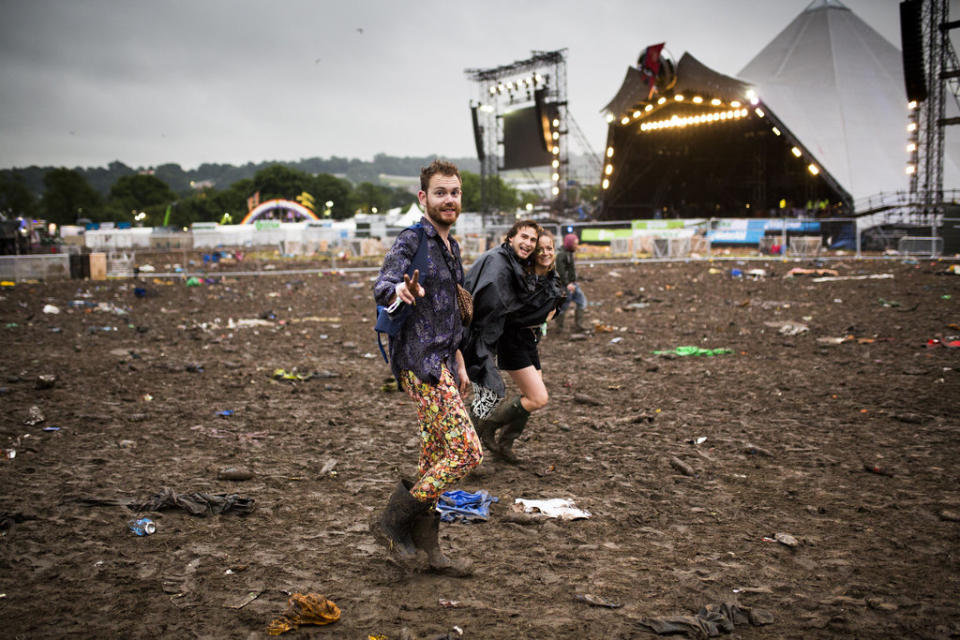 Revellers make their way home from the Glastonbury Festival.