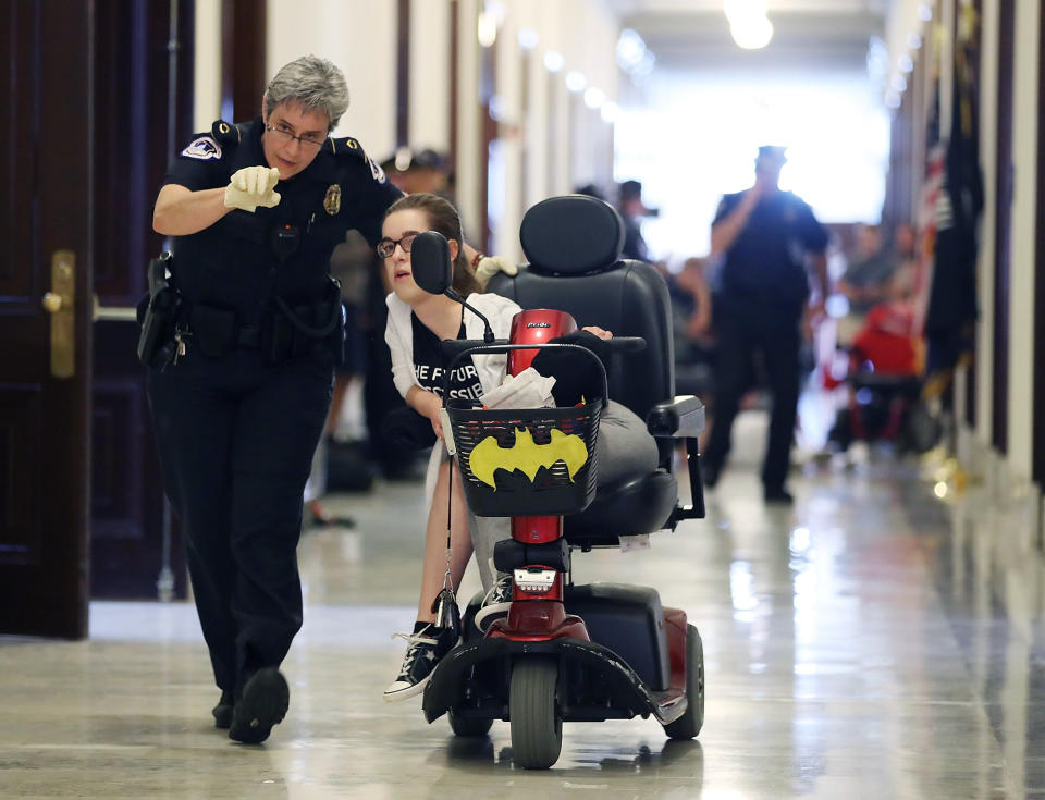 <p>U.S. Capitol Police remove a protester from in front of the office of Senate Majority Leader Mitch McConnell (R-KY) inside the Russell Senate Office Building on Capitol Hill, on June 22, 2017 in Washington. (Photo: Mark Wilson/Getty Images) </p>