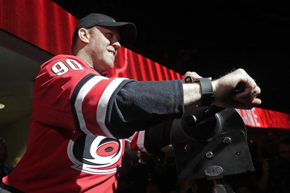 Dave Ayres sounds the siren before an NHL hockey game between the Carolina Hurricanes and the Dallas Stars in Raleigh, N.C., on Tuesday, Feb. 25, 2020. Ayres became a sudden hero to Hurricanes fans when he came into the game as an emergency goaltender in Toronto on Saturday and won the game. (AP Photo/Chris Seward)