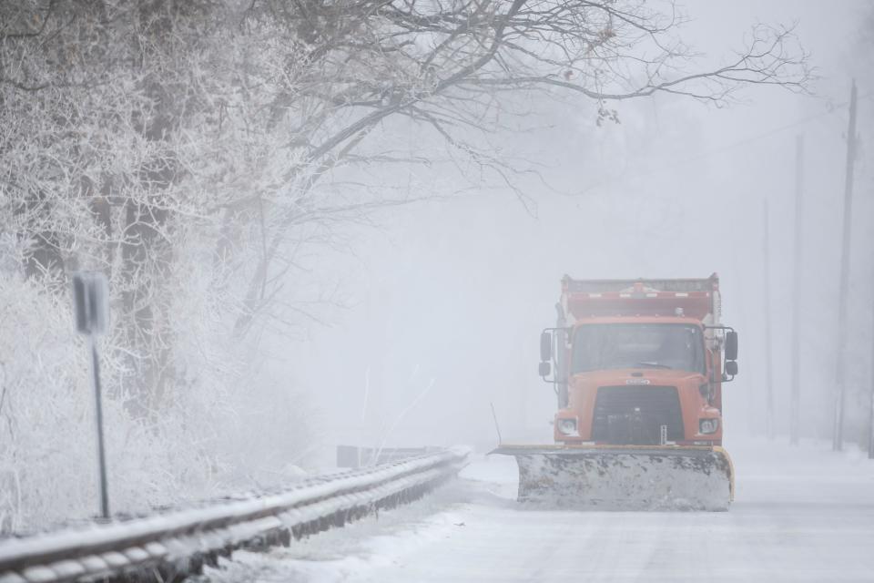 On River Road, a Metro plow truck cleared a lane Friday as subzero temperatures froze the Louisville area from Winter Storm Elliott.  Dec. 23, 2022 