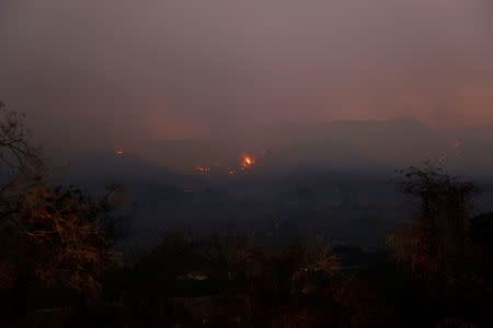 Wildfire flames burn on a hillside at sunrise during the Thomas fire near Montecito, California, U.S. December 12, 2017. REUTERS/Patrick T Fallon