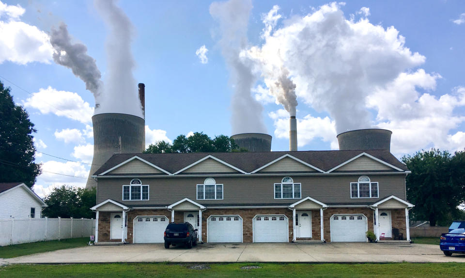 FILE - In this Aug. 23, 2018, file photo, a coal-fired plant in Winfield, W.Va, is seen from an apartment complex in the town of Poca across the Kanawha River. The Trump administration is gutting an Obama-era rule that compelled coal plants to cut back emissions of mercury and other human health hazards, limiting future regulation of air pollutants by petroleum and coal plants. (AP Photo/John Raby, File)