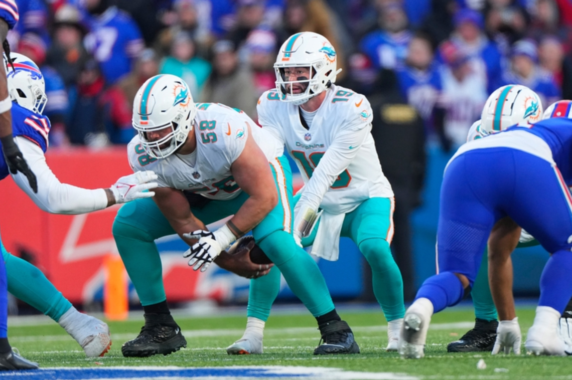 Miami Dolphins guard Connor Williams (58) snaps the ball to quarterback Skylar Thompson (19) during an AFC wild-card playoff game against the Buffalo Bills at Highmark Stadium in Orchard Park, New York, Jan. 15, 2023. Gregory Fisher/USA Today Sports