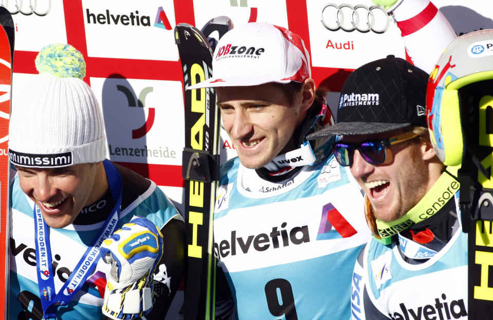 Austria's Matthias Mayer, center, the winner, second-placed Italy's Christof Innerhofer, left, and third-placed Ted Ligety, of the United States, celebrate after a men's alpine skiing downhill at the World Cup finals in Lenzerheide, Switzerland, Wednesday, March 12, 2013. (AP Photo/Armando Trovati)