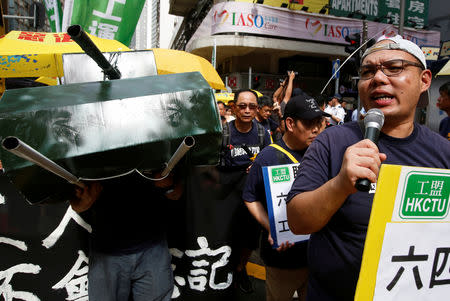 A protester carries a mock tank during a march ahead of June 4 anniversary of military crackdown on pro-democracy protesters in Tiananmen Square, in Hong Kong, China May 26, 2019. REUTERS/James Pomfret