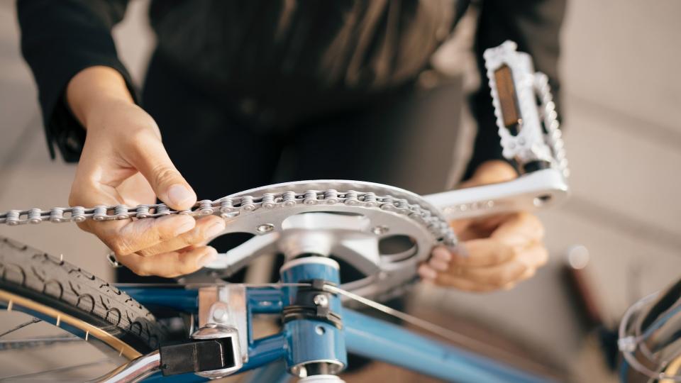 Person refitting bike chain