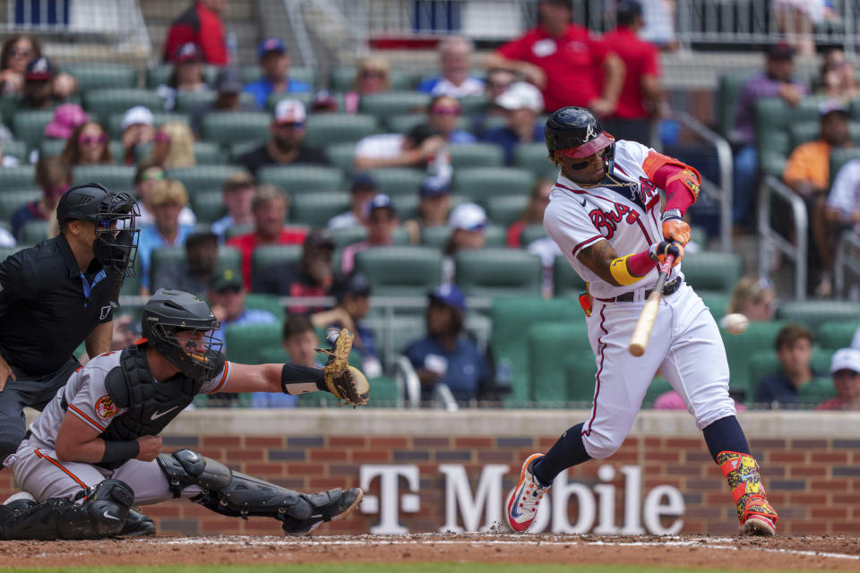 Baltimore Orioles' Luis Torrens, right, hits the ball in the third inning of a baseball game against the Baltimore Orioles, Sunday, May 7, 2023, in Atlanta. (AP Photo/Erik Rank)