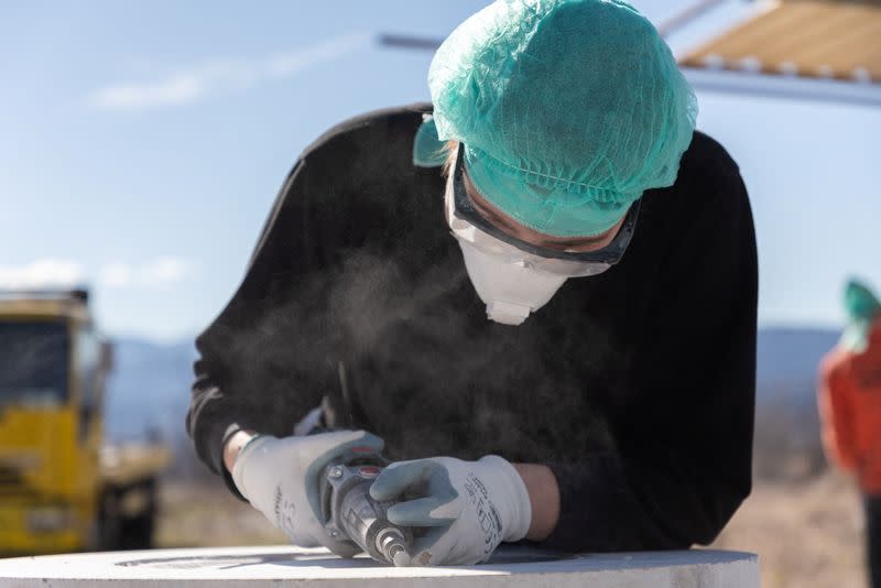 An artist works on a life size Mercedes monument in Imotski