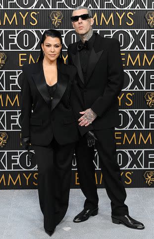 <p>David Fisher/Shutterstock</p> Kourtney Kardashian and Travis Barker at 2024 Emmys