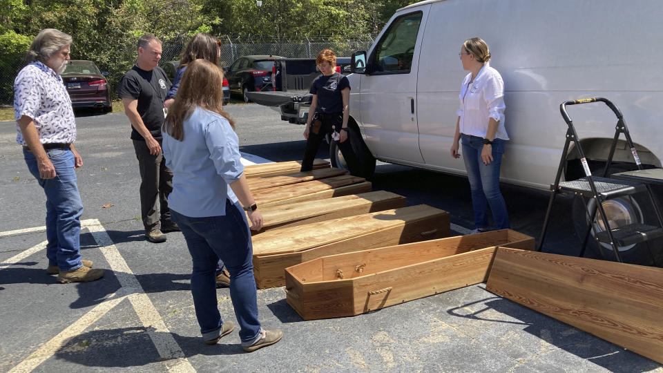 Forensic anthropologists, archeologists and volunteers prepare homemade coffins for the remains of unidentified Revolutionary War soldiers killed in the Battle of Camden in 1780 for reburial on Thursday, March 30, 2023, in Columbia, South Carolina. The remains were removed from the battlefield, studied and analyzed and will be buried in a ceremony. (AP Photo/Jeffrey Collins)