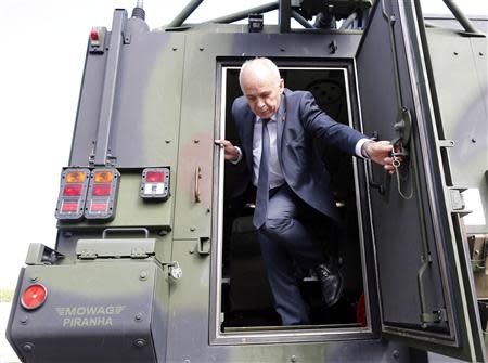 Swiss President and Defence Minister Ueli Maurer gets out of an APC during his visit to a Swiss army base in Lyss, near Bern in this August 29, 2013 file photo. REUTERS/Ruben Sprich/Files